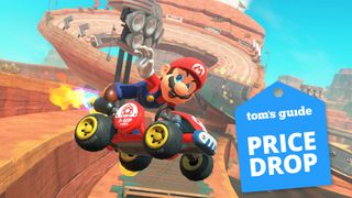 Mario kart world with price drop sticker, featuring mario in a red kart performing a stunt