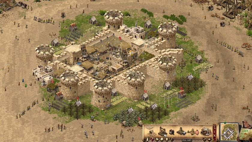A big sandstone castle in Stronghold Crusader: Definitive Edition, surrounded by workers milling about.