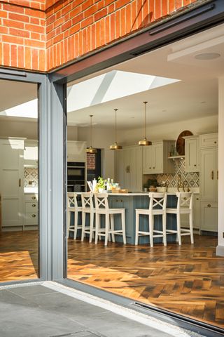 A glazed door looking into an open plan kitchen