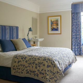 blue coloured bedroom with frame on wall