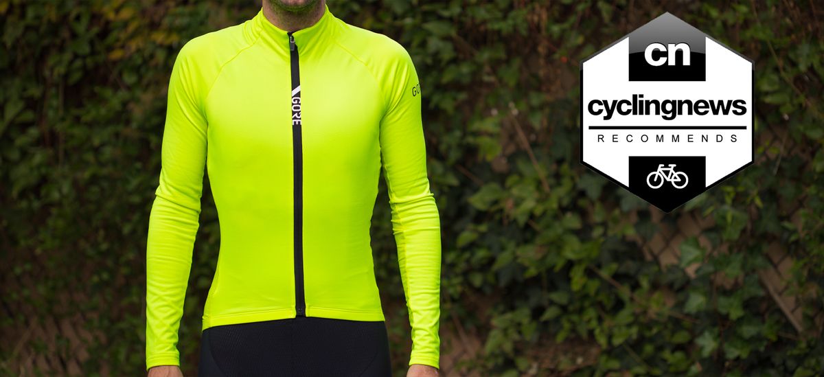 A front-on image of Josh wearing the neon yellow Gore C5 Thermo Jersey, with black zipper down the centre which features a white Gore logo. Image is overlaid with Cyclingnews &#039;recommends&#039; badge