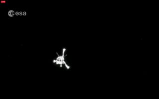 Europe's Rosetta orbiter photographs the mission's Philae lander after it deployed and headed down to the surface of Comet 67P/Churyumov-Gerasimenko on Nov. 12, 2014.