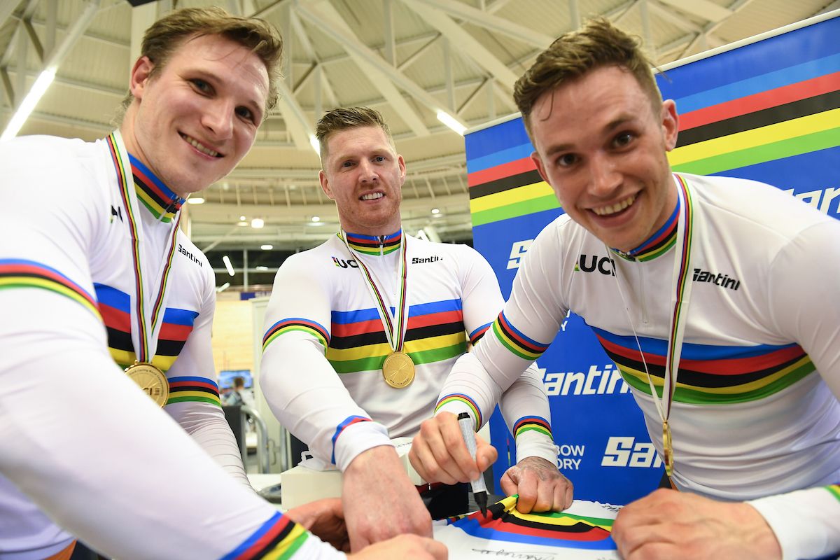 Picture by Simon Wilkinson/SWpix.com - 20/10/2021 - Cycling - Tissot 2021 UCI Track Cycling World Championships - Men&acirc;s Team Sprint - Stab Velodrome, Roubaix, France - Jeffrey Hoogland, Harrie Lavreysen and Roy van den Berg of the Netherlands sign a Santini Jersey after winning the men's team sprint to become World Champion