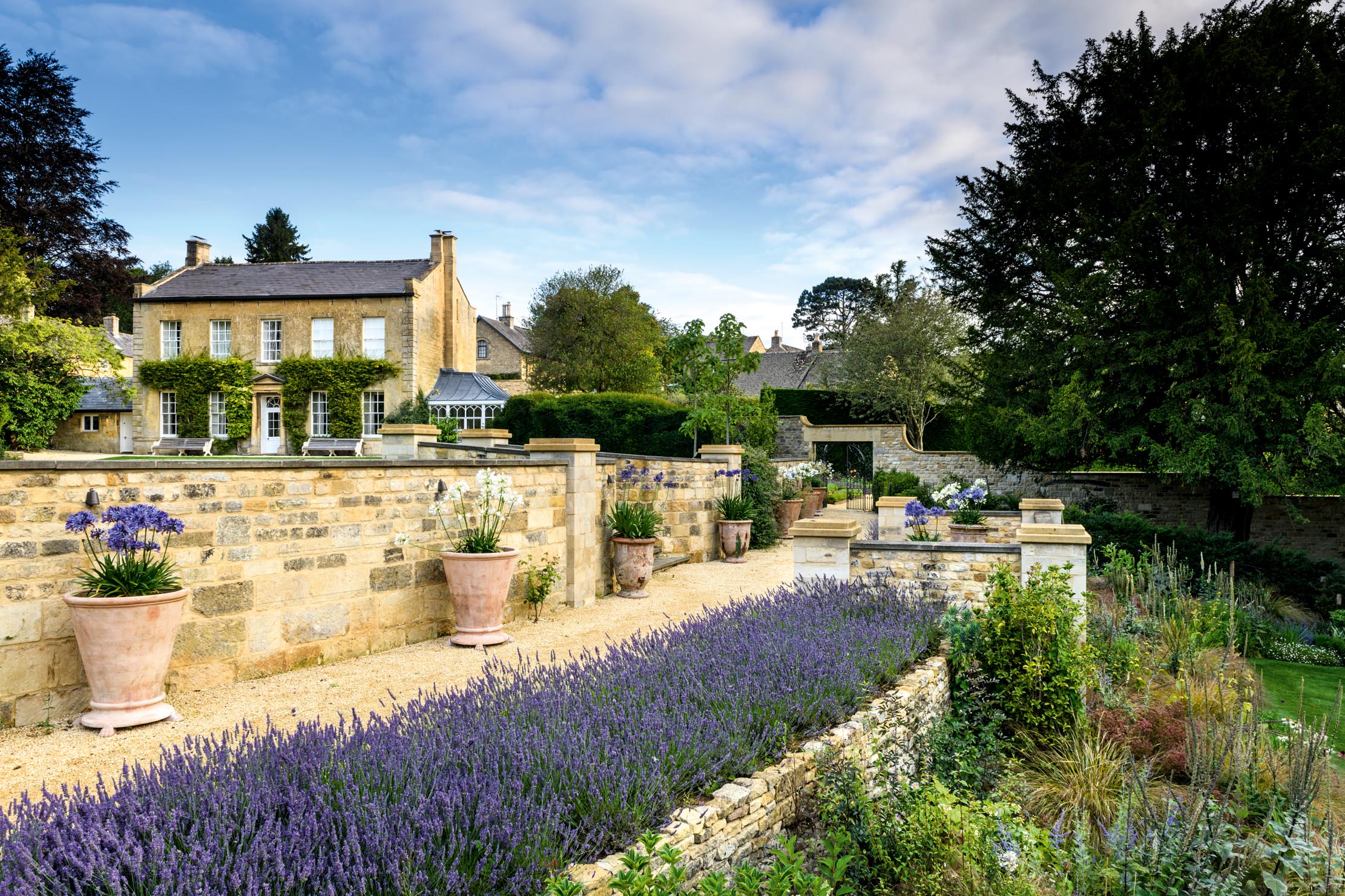 Colebrook House, Gloucestershire. The restored terrace has been given fresh emphasis and lends a strong visual link from the house to the garden. ©Jason Ingram