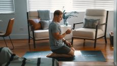 Pliability athlete Noah Ohlsen starting a mobility routine in his living room 