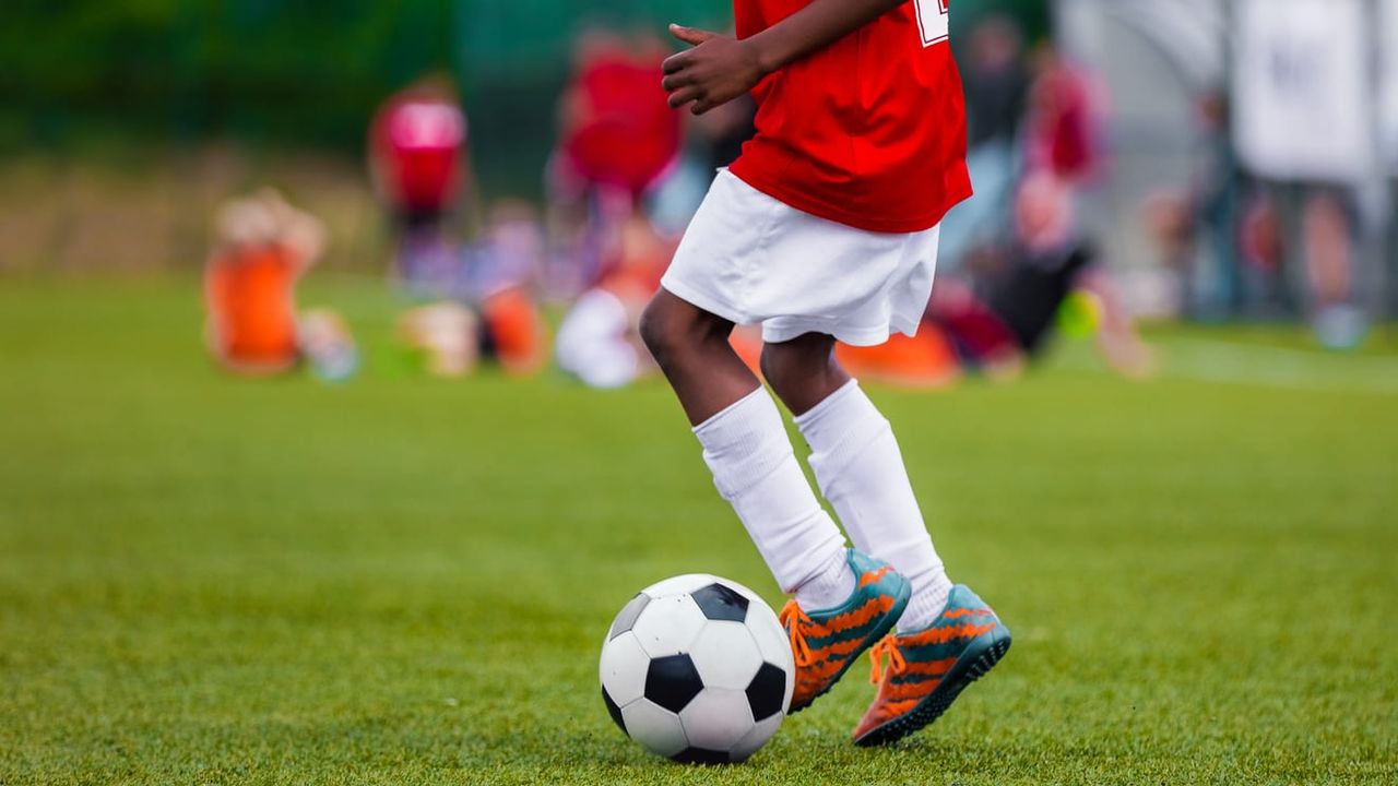 A boy plays soccer.