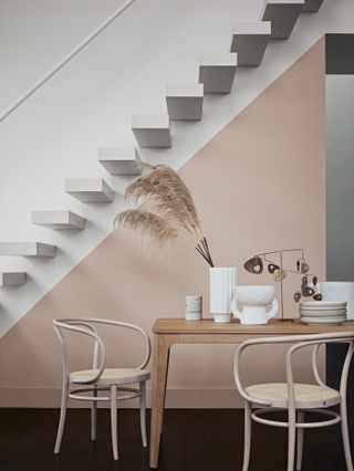 dining area with a diagonal pink colour block on the wall