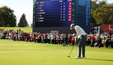 Michael Kim hits a putt