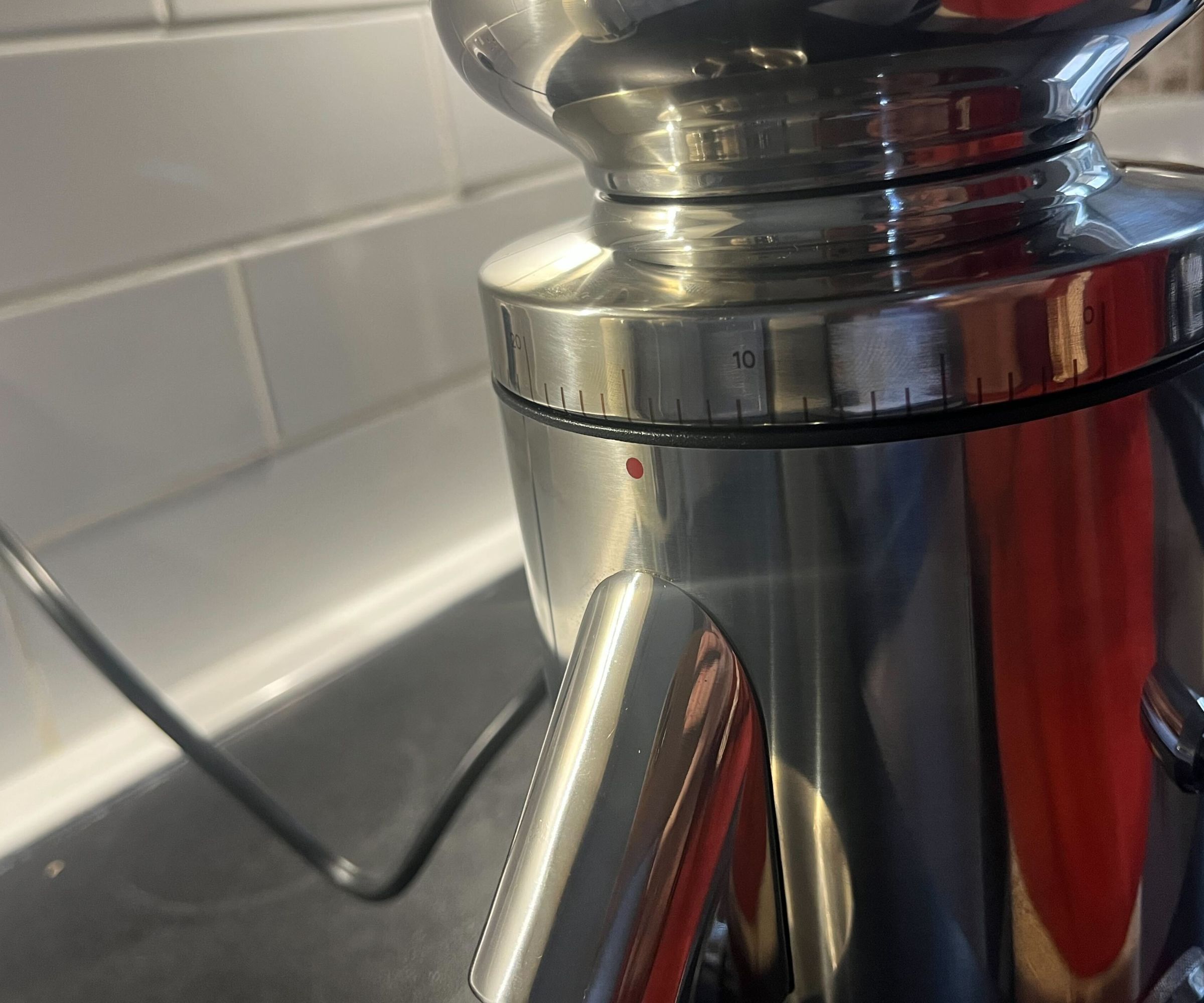 A close up image of the grind settings on a stainlesssteel coffee grinder