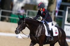 Sophie Wells pats LJT Egebjerggards Samoa on the neck as the mare wals out of the arena at the 2023 European Championships on a loose rein.