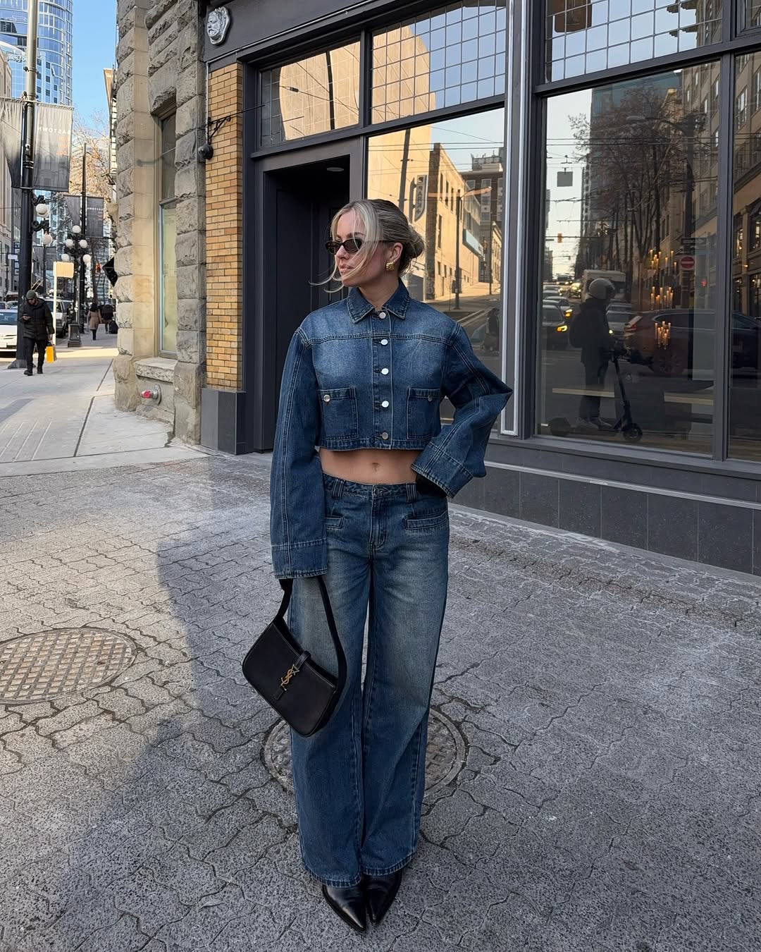 woman wearing dirty denim wash jeans fall denim trend 2025