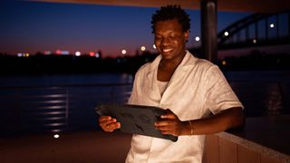 A man playing the Acer Nitro Blaze 11 at night.