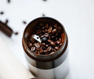 A coffee grinder with coffee beans inside