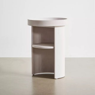A rounded wooden side table with shelves