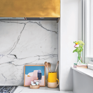 Kitchen utensils in white marble kitchen