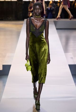 how to wear velvet is shown in a photo from Gucci's fall 2024 runway show with a model wearing a green choker necklace with a green velvet green, green bag, and green pumps