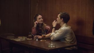 Martin (Jonas Nay) connects with his son's teacher Nicole (Svenja Jung) at a bar