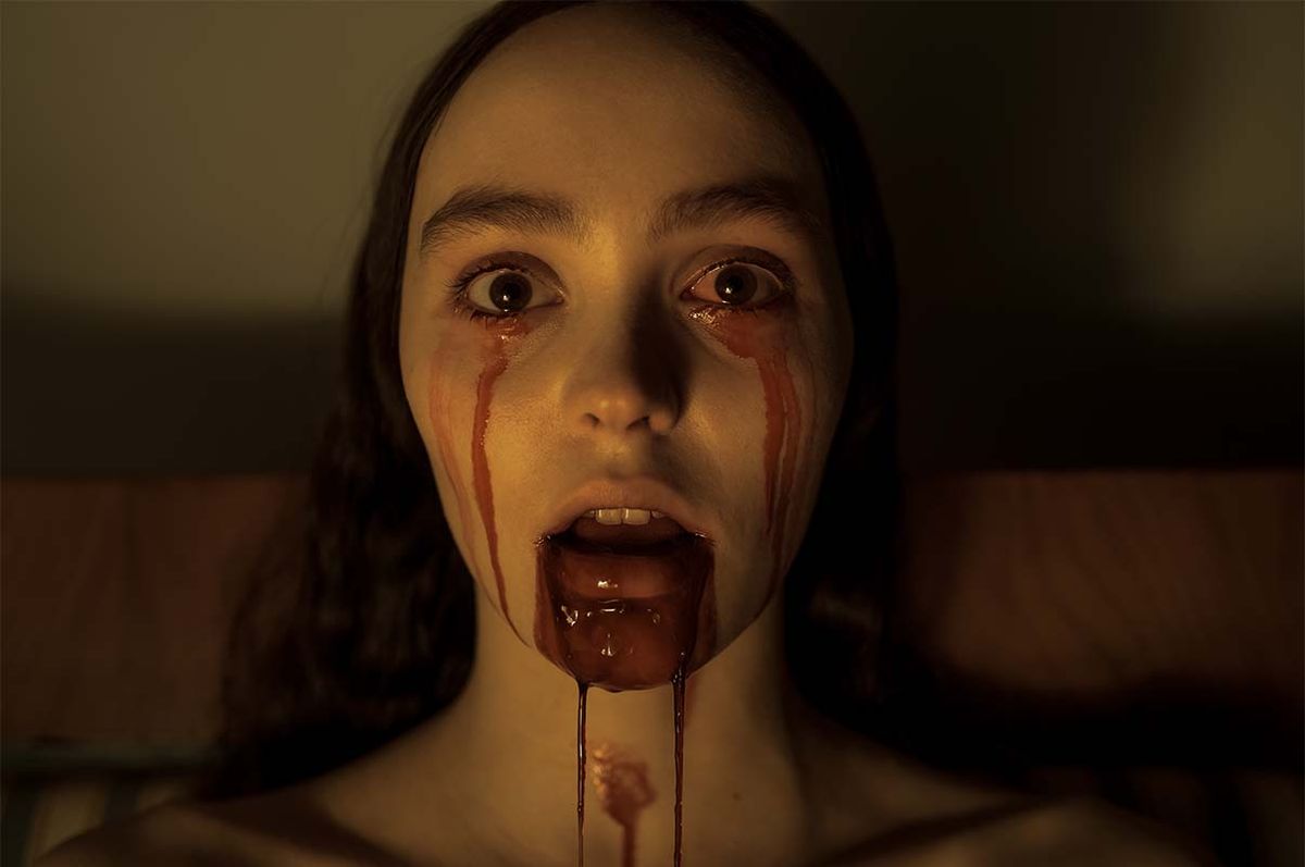 Close-up of Ellen Hutter (Lily-Rose Depp) with blood pouring from her eyes and mouth as she stares directly into the camera 