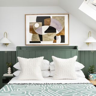 abstract art above bed with green wall panelling