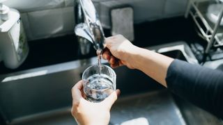 Pouring a glass of water from the kitchen tap