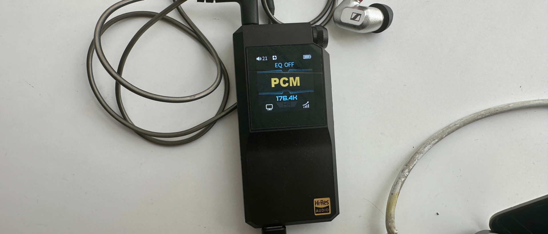 FiiO BTR17 on a gray table, showing PCM resolution in yellow 