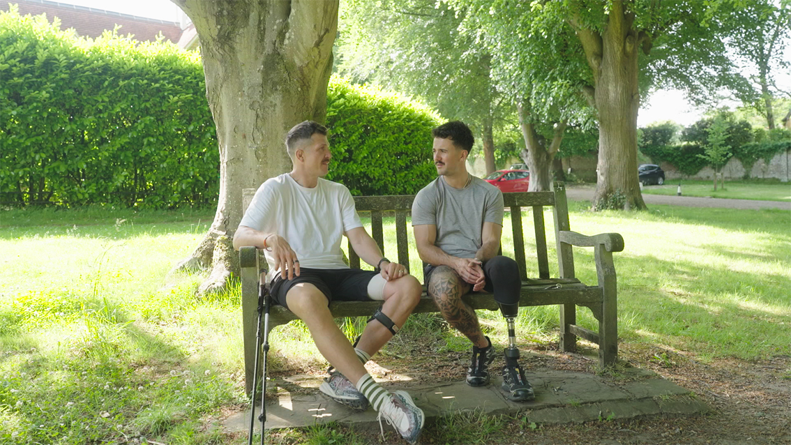 Ed Jackson and Luke Tarrant sit together on a bench