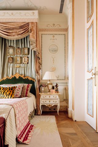 Grren velvet bed head with gold design, white bedside table with gold detailing,