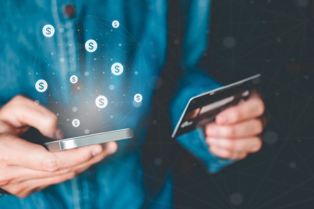 Man holding card and phone with fintech app