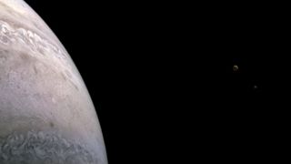 Taken during Juno's 39th close flyby of Jupiter on Jan. 12, 2022, this stunning view captures two of the planet's moons: Io (left) and Europa (right).