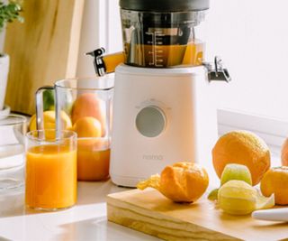 The base of a Nama J2 juicer making orange juice