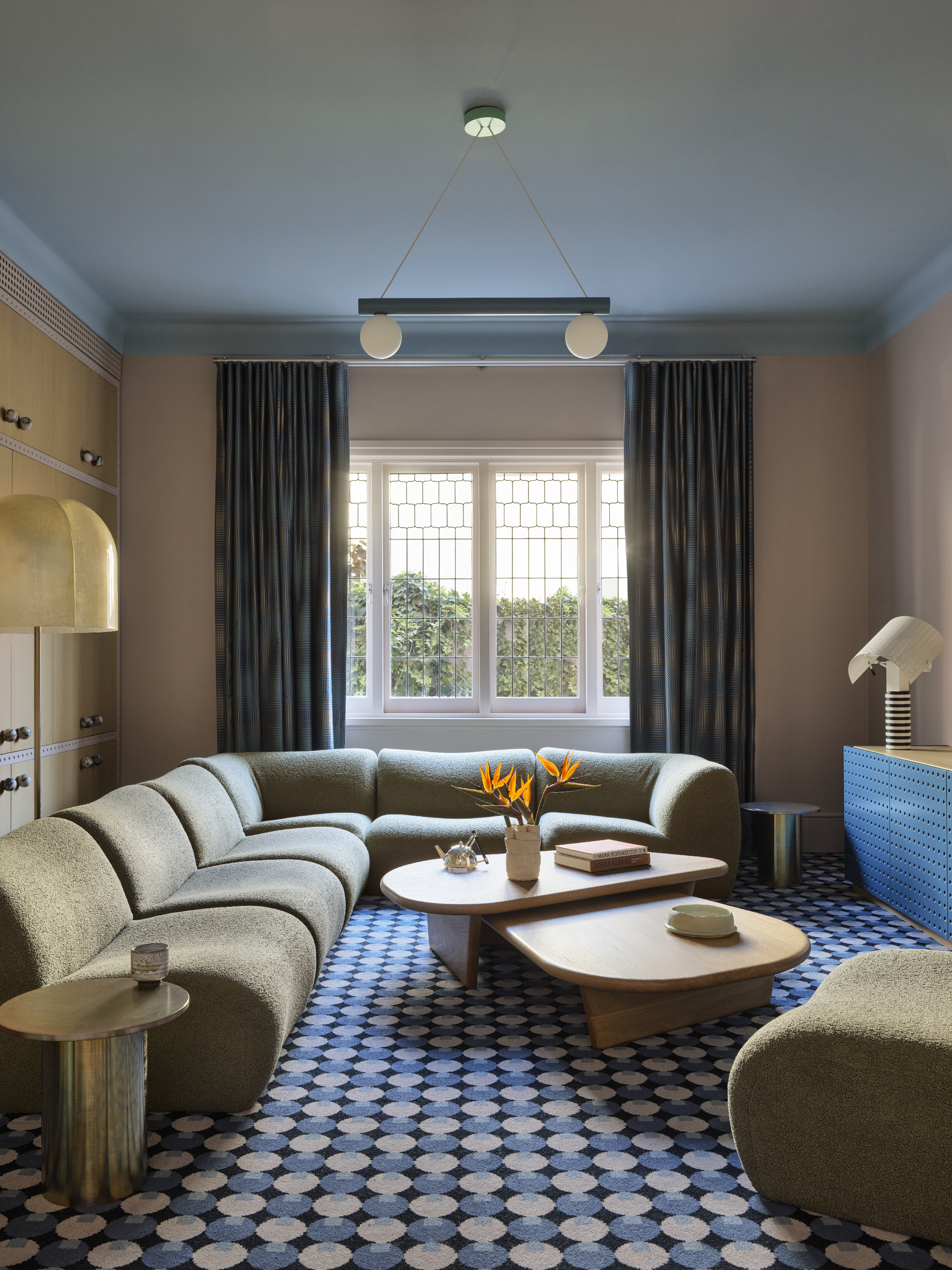 a colorful living room with a modular sofa and patterned rug