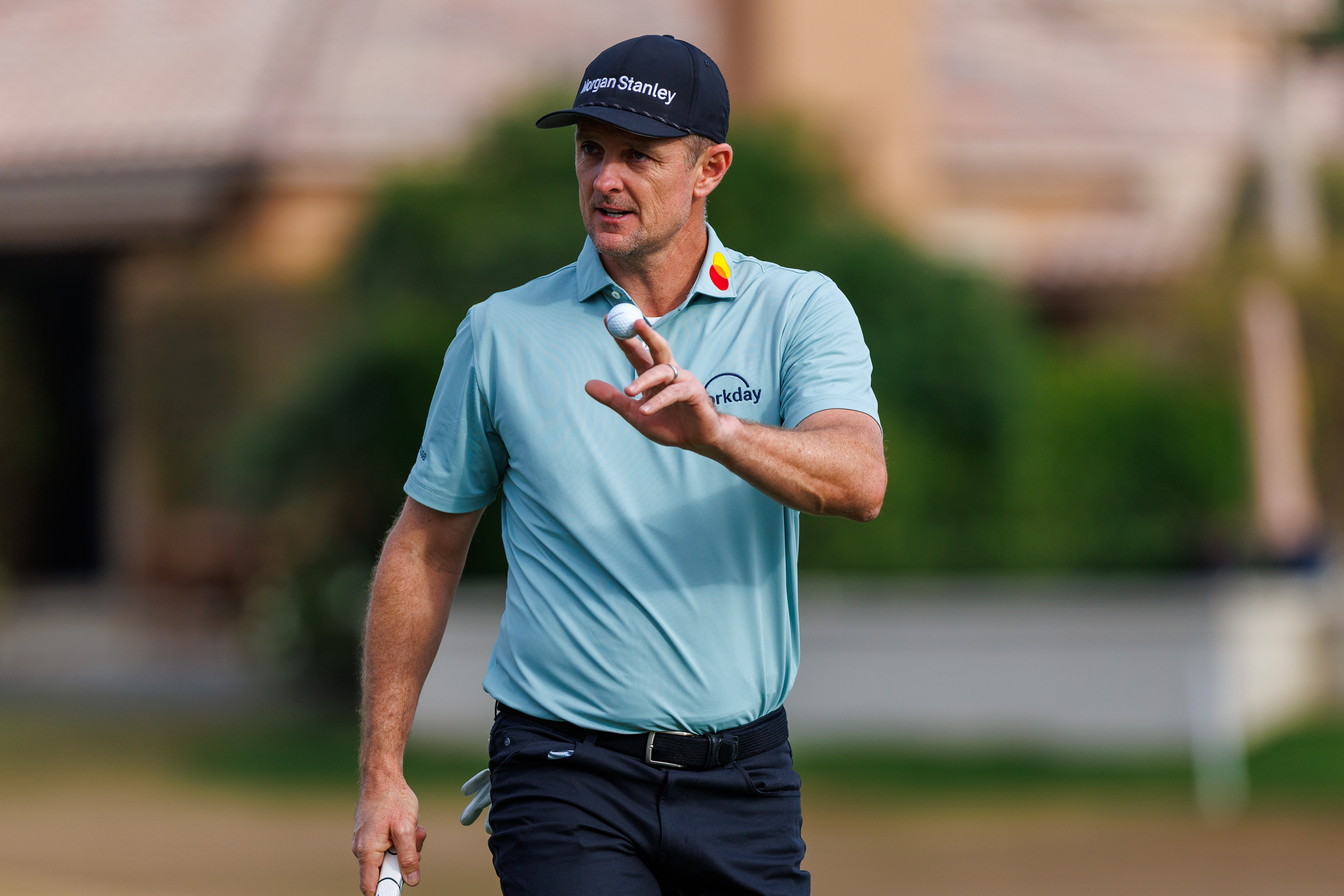 Justin Rose waves to the crowd after holing a putt