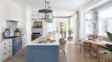 kitchen with blue island and vintage rug