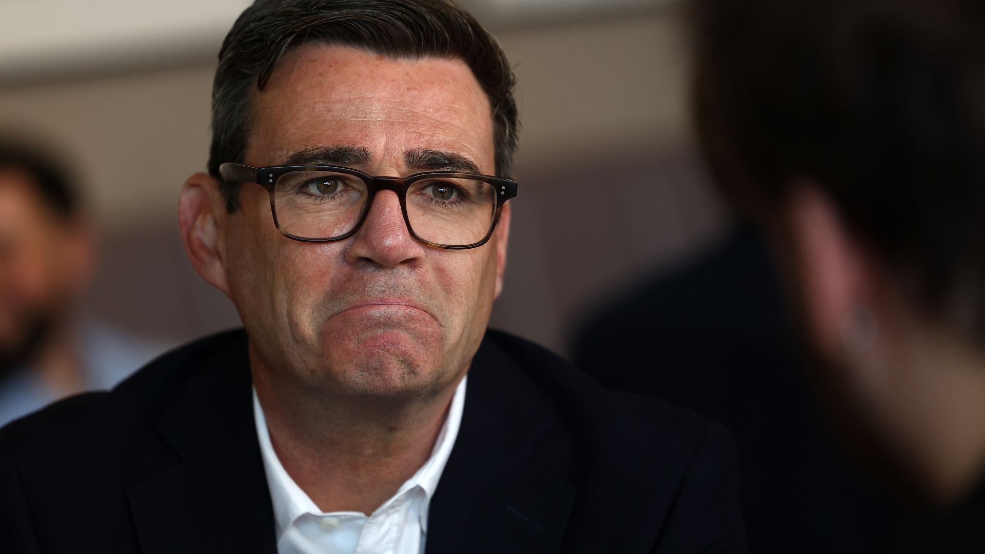 UK Prime Minister Andy Burnham reacts as he meets with local business owners and guests during a visit to The Hub cafe on August 11, 2026 in Ilkeston, England. 