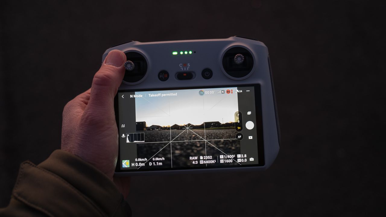 DJI Mavic 3 Pro smart controller held in one hand at night