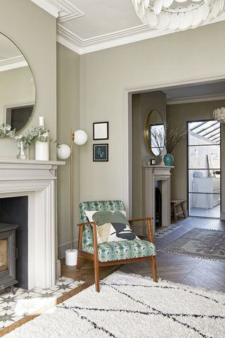 Pale green living room with fireplace and berber style rug