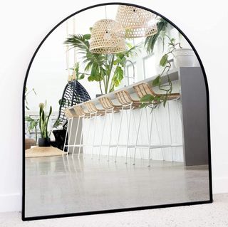 Black arched mirror in a room