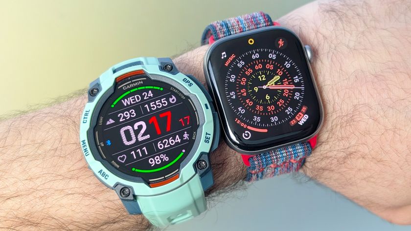 Close-up of the Garmin Instinct 3 next to the Apple Watch Series 11