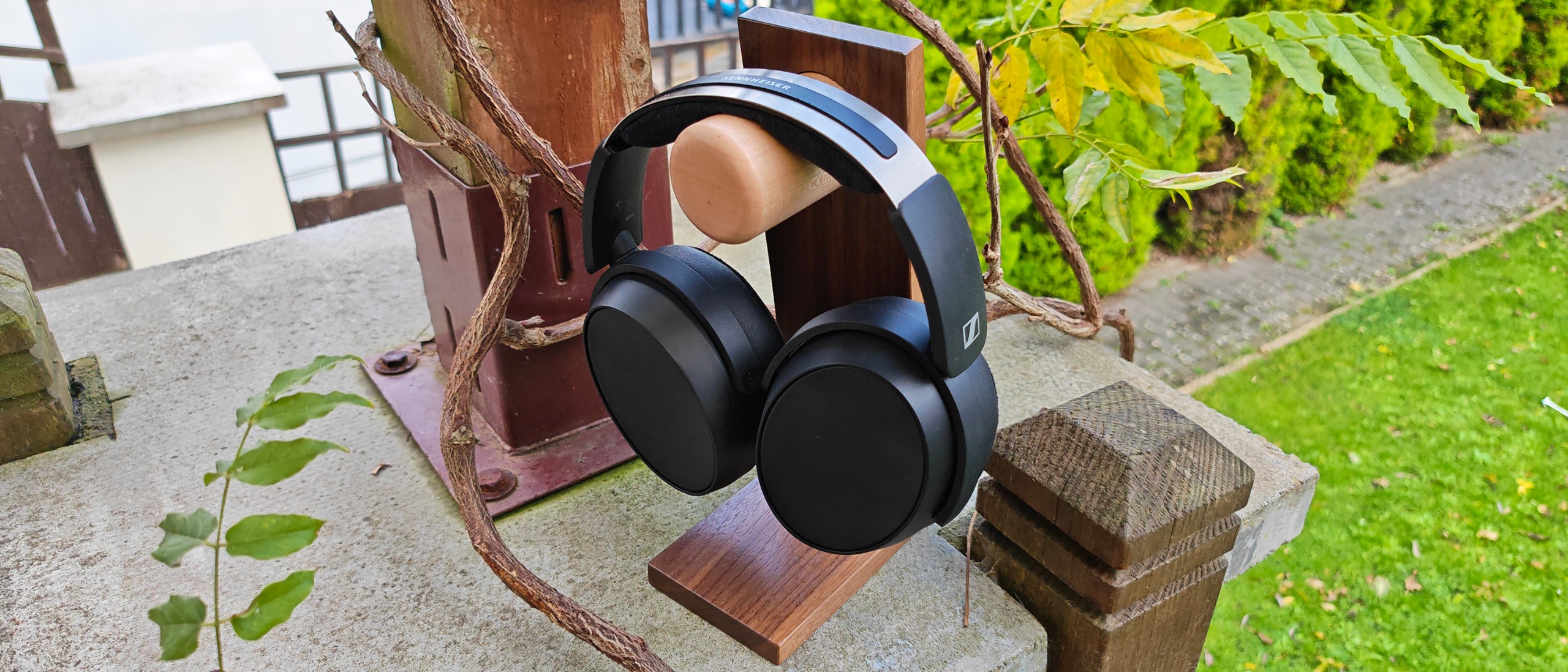The Sennheiser HD 480 Pro headphones outside next to some greenery. 