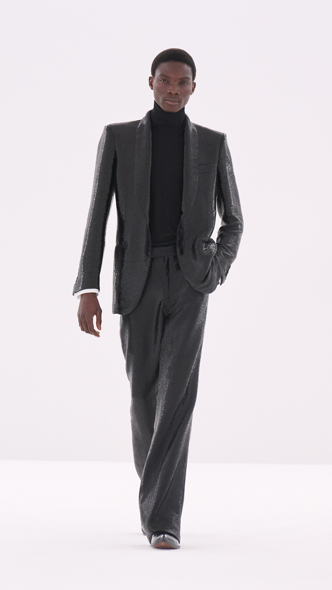 a Tom Ford model wearing a black sequin suit on the runway
