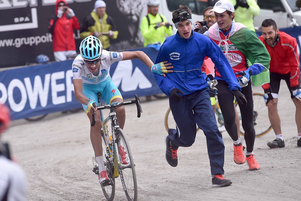Fabio Aru pushes a fan out the way.