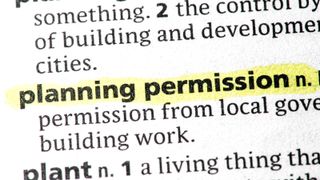 close up of document with words planning permission highlighted in yellow