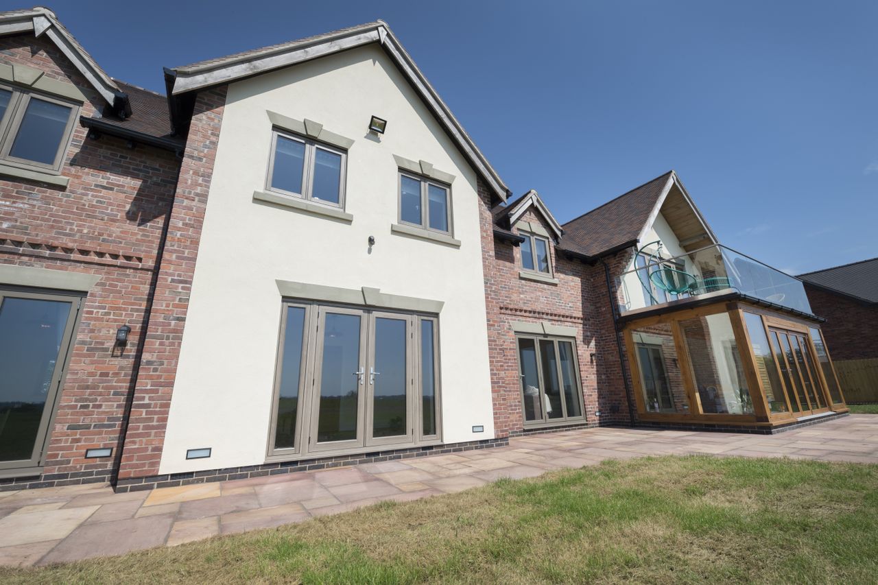 brick and render building with traditional style windows