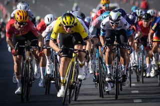 Visma-Lease a Bike team's Dutch rider Olav Kooij (C) competes to win the fourth stage of the Tour of Oman cycling race from Oman Across Ages Museum to Oman Convention Center, on February 11, 2025. (Photo by Loic VENANCE / AFP)