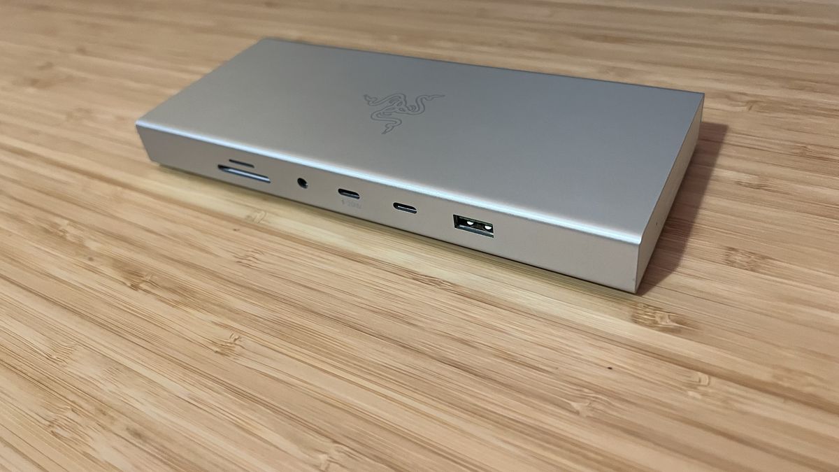 Razer USB 4 Dock in silver on a wooden desk