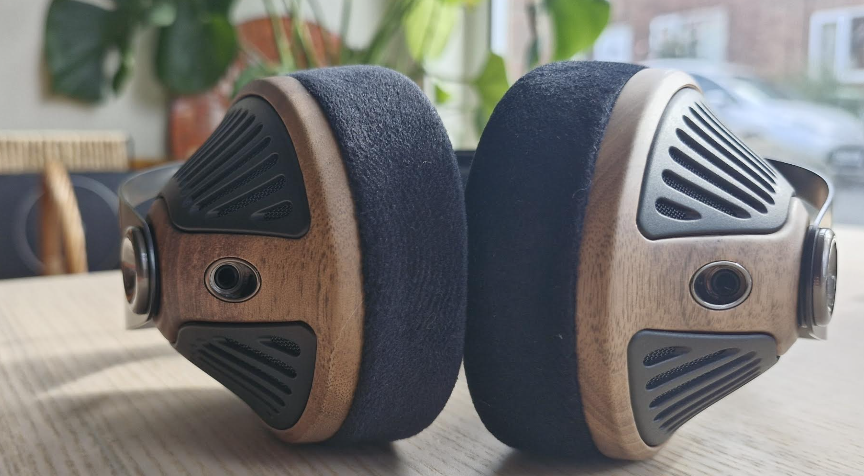 Meze Audio 105 Silva headphones on a light wooden table