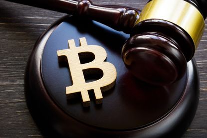 A bitcoin symbol on a gavel to symbolize cryptocurrency regulation.
