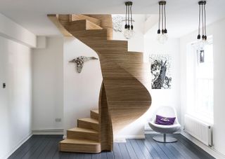 A spiral staircase in a light coloured timber.