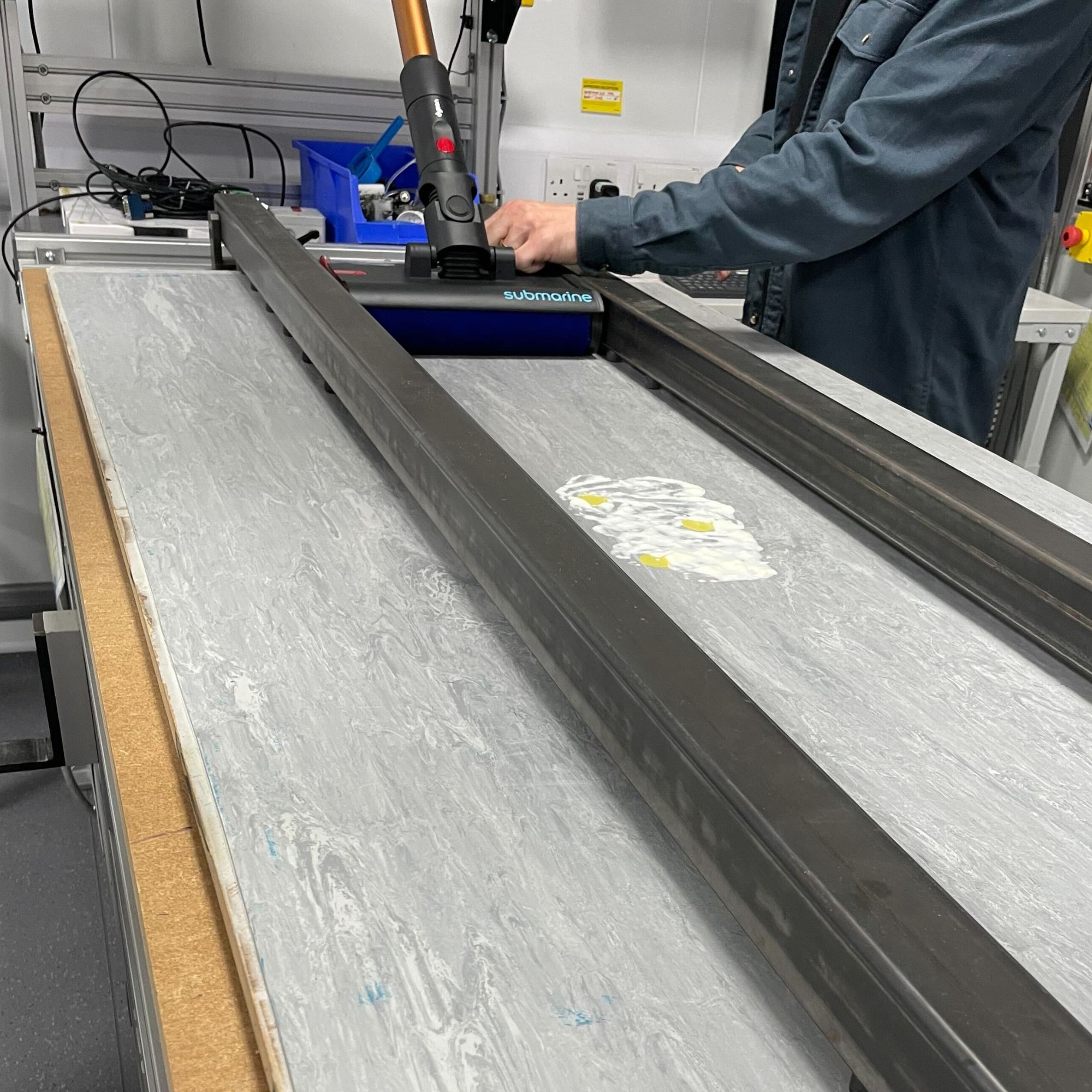 Dyson V16 Piston Animal Submarine on a testing tray, cleaning up wet messes