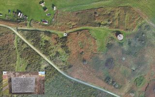 Aerial view of the site of the former labor and concentration camp of Sylt, and the memorial plaque installed on the camp gateposts in 2008, by a survivor.